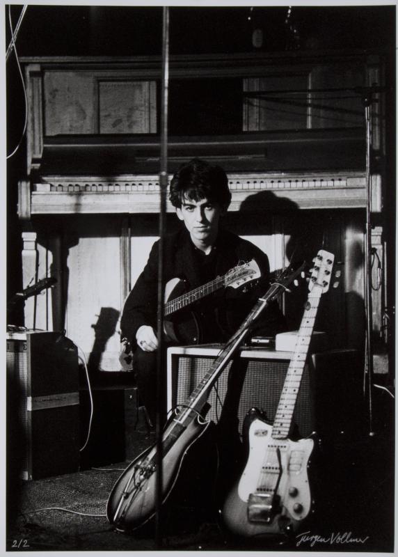 GEORGE HARRISON PHOTOGRAPH SIGNED BY JURGEN VOLLMER: An original black and white photograph of George Harrison at the Top Ten Club, Hamburg, Germany, in 1961 taken by photographer Jurgen Vollmer and signed on the bottom right by Vollmer in silver felt p