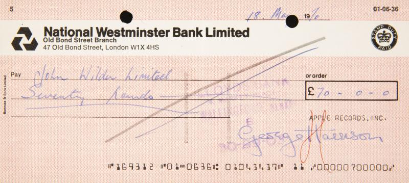 GEORGE HARRISON SIGNED CHECK: A National Westminster Bank Limited check for £70 payable to John Wilder Limited and dated May 18, 1970. Signed by George Harrison in blue ballpoint ink. Accompanied by a certificate of authenticity
