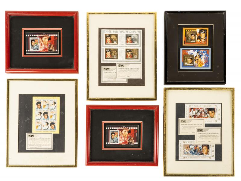 ELVIS PRESLEY COMMEMORATIVE STAMPS • °: A group of six frames containing commemorative Elvis Presley stamps, some with certificates of authenticity that include the issue number. The stamps are from Guyana, Mali, Gambia, and Madagascar. Lar