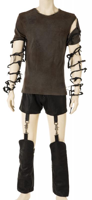 TRENT REZNOR STAGE WORN ENSEMBLE: An ensemble worn by Trent Reznor during live performances with Nine Inch Nails on the band's 1994 to 1996 Self-Destruct Tour. The ensemble comprises a ripped gray and maroon T-shirt, a pair of leather