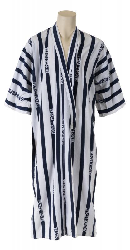 MICHAEL JACKSON PRINCE HOTEL ROBE: A blue and white striped robe from Prince Hotel. No labels present. Accompanied by a photograph of Michael Jackson and sister La Toya Jackson with the robe draped across their laps. Michael Jackson