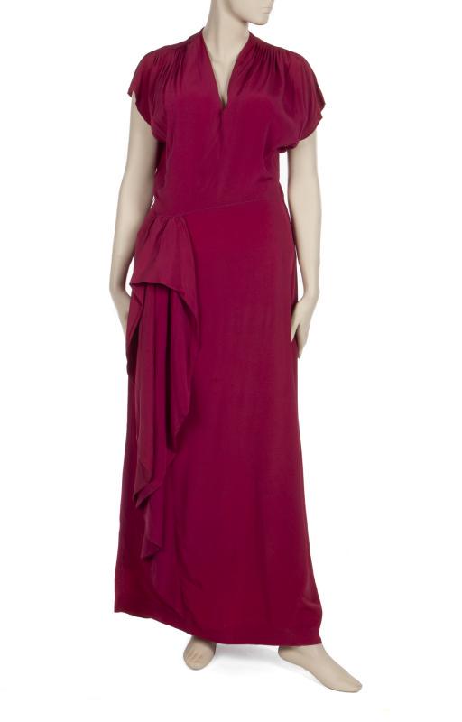 MAE WEST GOWN AND JACKET: A circa 1940s custom-made dress and jacket. A slender fuchsia short-sleeve gown with swag to the hip. A black crepe wrap over jacket with loop and fabric-covered buttons to the cuffs. Mae West