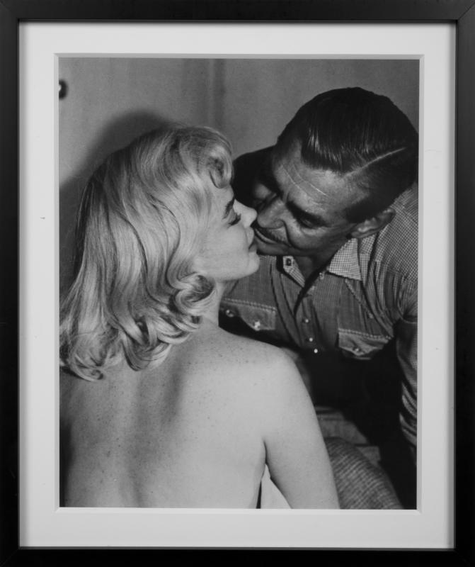 MARILYN MONROE BLACK AND WHITE PHOTOGRAPHS FROM THE: United Artists, 1961. A set of two, both later prints with a glossy finish; the first depicts the star with Clark Gable; the second depicts the star wearing her cherry dress on the set; beautifully ma