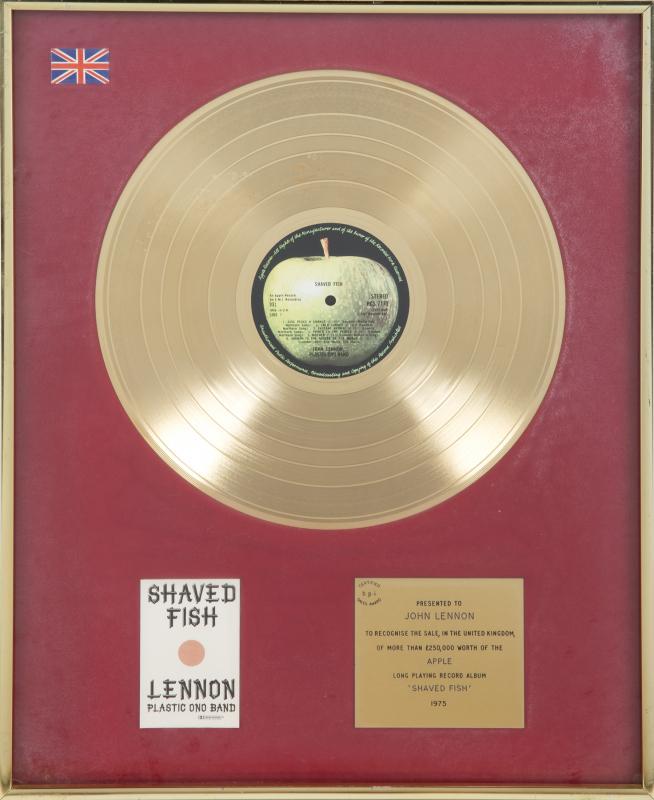 JOHN LENNON PLASTIC ONO BAND SHAVED FISH "GOLD" RECORD: Request condition report! A British B.P.I. “gold” record award presented to John Lennon for the 1975 compilation album Shaved Fish. 20 1/4 by 16 1/4 inches Rock 'N' Roll