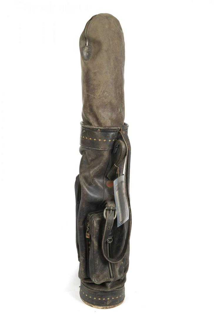 IRVING BERLIN PERSONALIZED GOLF CLUBS AND BAG: A golf bag containing 12 wood and metal clubs belonging to Irving Berlin circa 1930. The wood clubs have “IB” engraved in gold, and the metal irons have “IB” engraved on the steel. Attached to