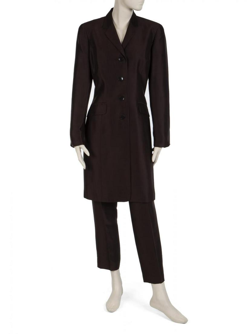 WHITNEY HOUSTON EVENT WORN ENSEMBLE AND PRESS CLIPPINGS: A chocolate brown silk ensemble worn by Whitney Houston to the Million Family March in Washington, D.C., in 2000. The ensemble consists of a long jacket and a pair of trousers. Each piece has an Ann T