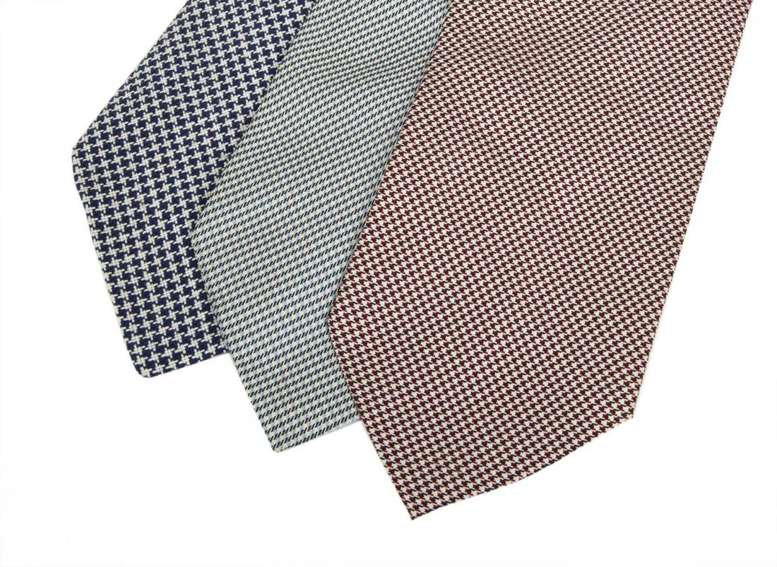 ROBERT EVANS VINTAGE TIES: Two vintage patterned Carroll & Company silk ties, together with a houndstooth wool Fox Hills tie. PROVENANCE From the Estate of Robert Evans Hollywood