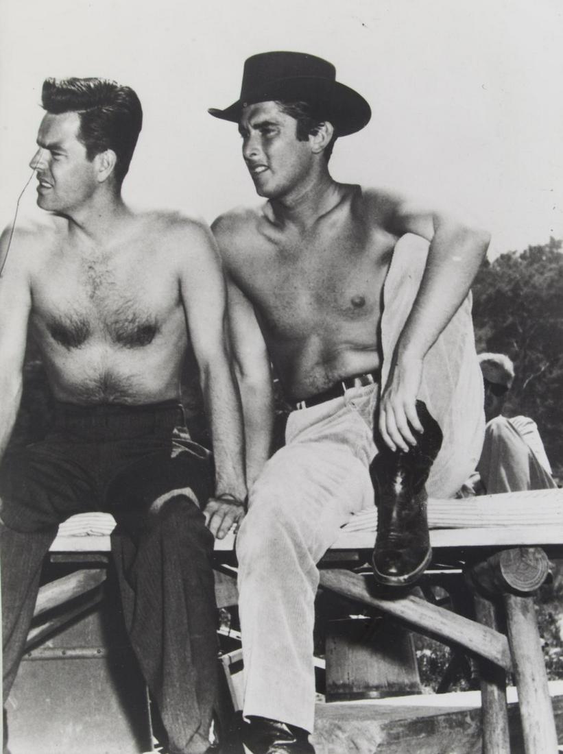 ROBERT EVANS AND ROBERT WAGNER PHOTOGRAPH: A vintage black and white photograph of Robert Wagner with Robert Evans, both bare chested and seated on a log fence. 13 by 10 inches; 14 3/4 by 12 inches, framed PROVENANCE From the Estate of Robert