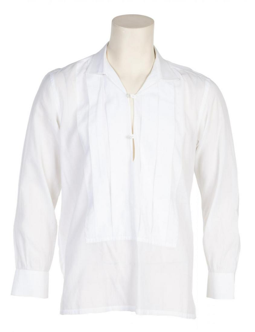 ROBERT EVANS CUSTOM ANTO BEVERLY HILLS SHIRT: A white cotton pleated long-sleeve shirt with hasp closures. With a tag reading "RE" and a date label. No size tag. PROVENANCE From the Estate of Robert Evans Hollywood
