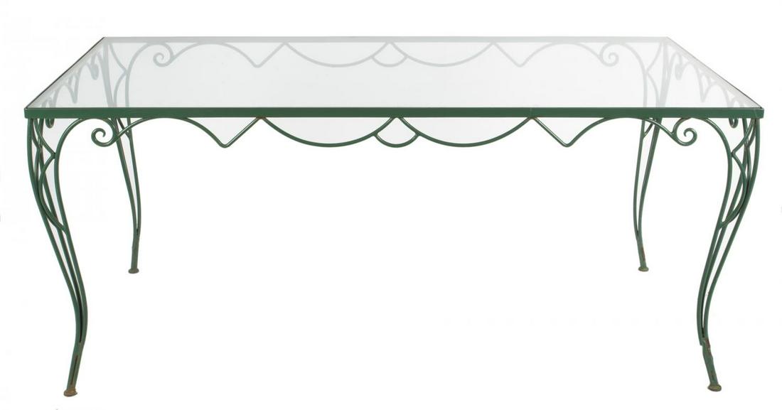 ROBERT EVANS GARDEN DINING TABLE AND CHAIRS AND BOOK: A vintage painted iron rectangular dining table with a glass top, together with 11 shield back armchairs with loose seat cushions. This set is featured in a photograph of the garden at Woodland, appea