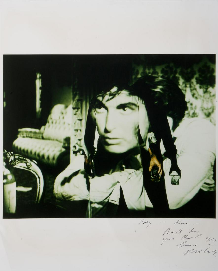 ROBERT EVANS MICHEL COMTE PHOTOGRAPH: A portrait of Robert Evans in his screening room holding a tumbler of scotch with an image from The Fiend Who Walked the West (20th Century Fox, 1958, starring Robert Evans) projected in the backgroun