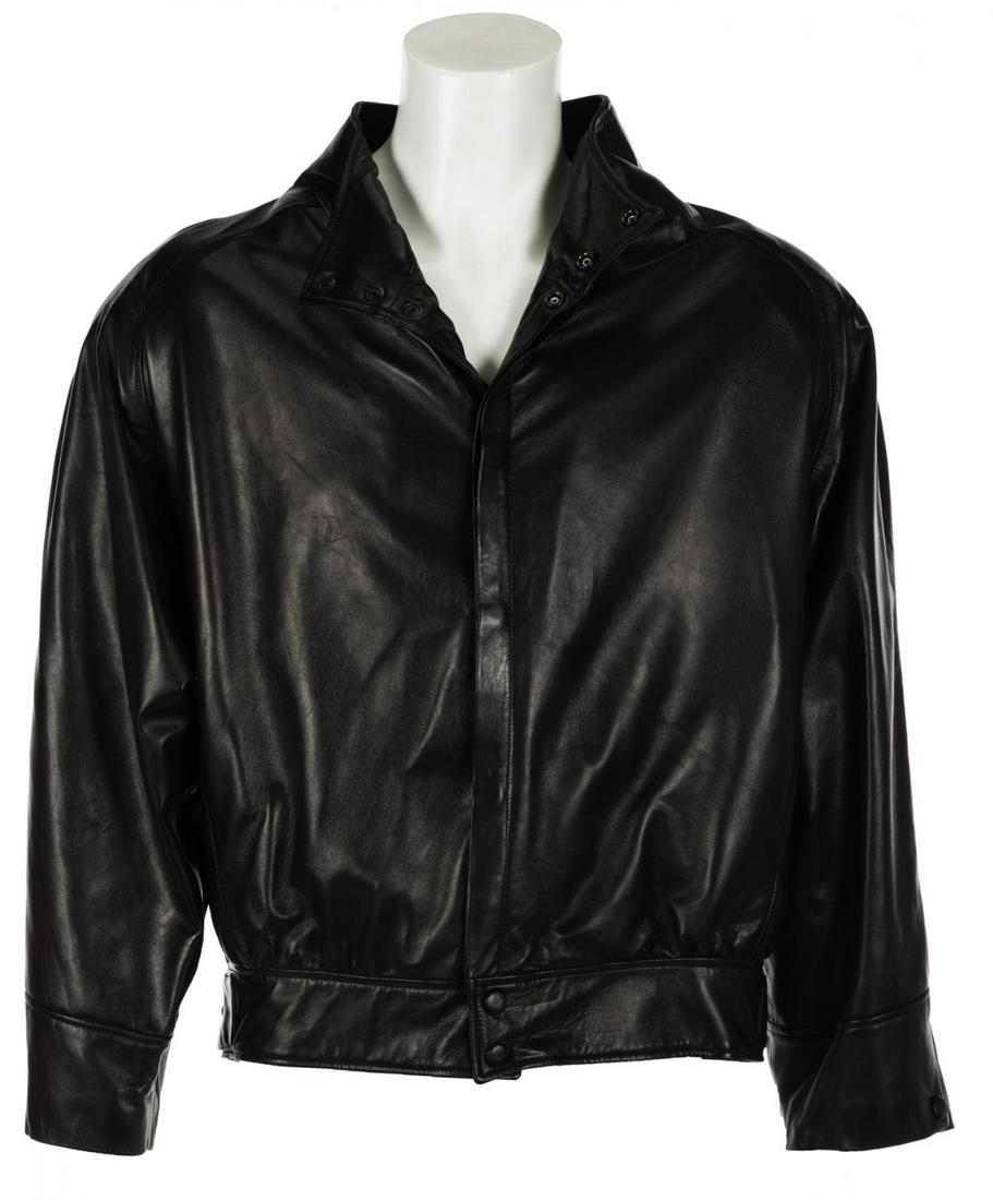 HUGH HEFNER LEATHER JACKET: A black leather bomber jacket labeled “Leather To The Limit” with snap button front closure, two side pockets and adjustable waist hem. No size label present. Length, approximately 26 inch