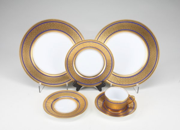 BERNARDAUD DINNER SERVICE: With cobalt and gilded rims, comprised of fifteen 10 1/2" dinner plates, sixteen 8 1/2" salad plates, fifteen 6 1/2" bread and butter plates, sixteen 5 1/2" saucers, and fourteen cups