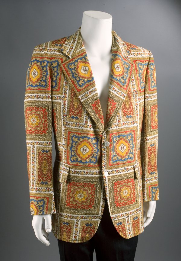 LIBERACE SPORT COAT: Multi-color single breasted jacket with two button closure owned and worn by Liberace, label reads "Morrie Geyer/Palm Spings." Mr. Showmanship cultivated a style all his own, including wild and lavish