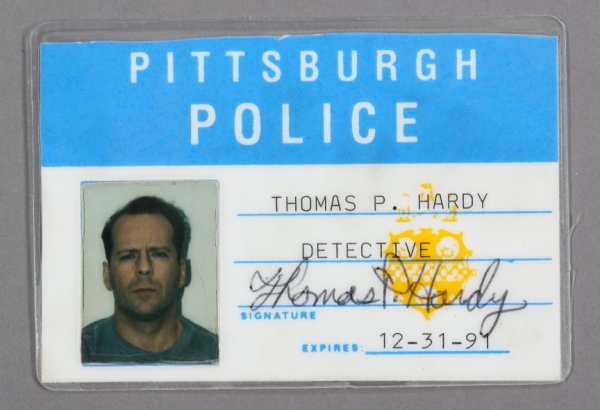 BRUCE WILLIS PROP POLICE BADGE: Prop police badge with an image of actor Bruce Willis that reads, "Pittsburgh Police/ Thomas P. Hardy/ Detective" from the film "Striking Distance" (Columbia Pictures Corp, 1993). In the film Willis i