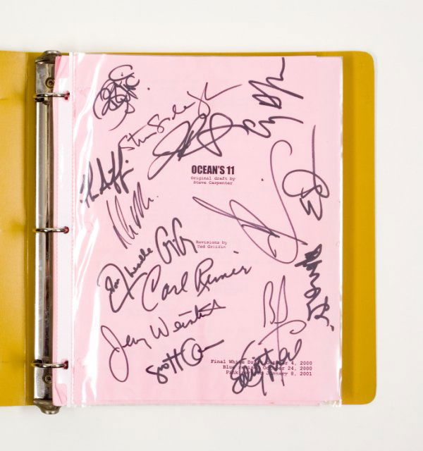 "OCEAN'S 11" SIGNED SCRIPT: "Ocean's 11" script bound in a yellow three-ring binder, from the 2001 Warner Bros. remake of the rat pack, buddy film. Cover page signed by the all-star cast, Bernie Mac, Julia Roberts, Brad Pitt, Ge