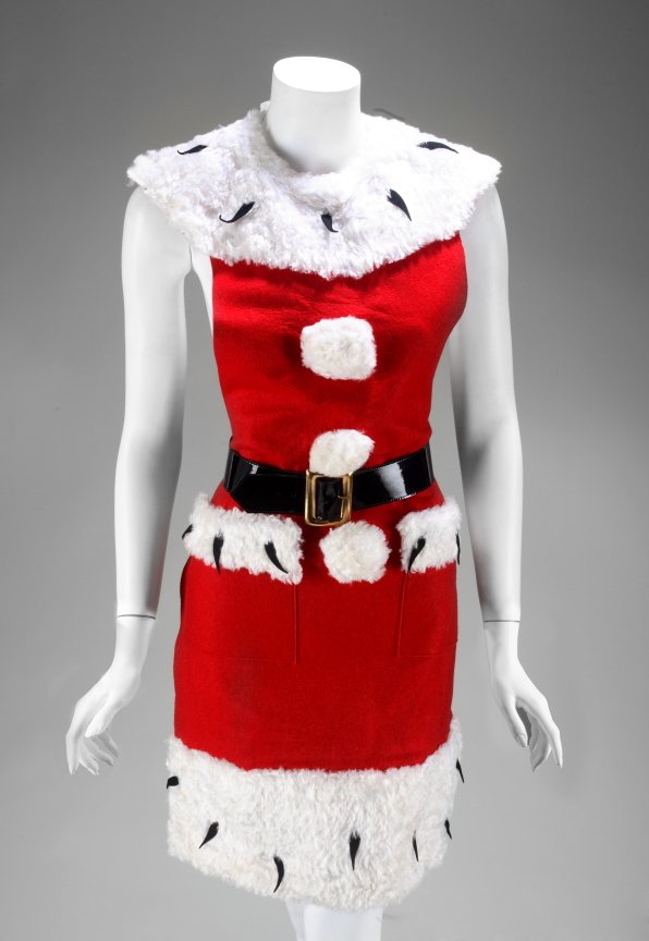 ANN MILLER SANTA CLAUS COSTUME: Red Santa Claus apron with faux ermine fur accents, black patent leather belt, and matching hat from an unknown performance by Ann Miller. PROVENANCE From the Estate of Ann Miller.