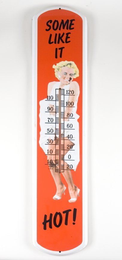 MARILYN MONROE PROMOTIONAL THERMOMETOR: Painted tin promotional thermometer displaying a caricature of Monroe from "The Seven Year Itch" and reads, "Some Like It Hot." Some paint loss due to age. 39 by 8 inches