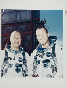 NASA GEMINI 5 ASTRONAUTS CONRAD AND COOPER PHOTOGRAPH: An original NASA color photograph featuring astronauts Charles Conrad and Gordon "Gordo" Cooper following a training session for their upcoming Gemini 5 mission. The photograph bears the red number