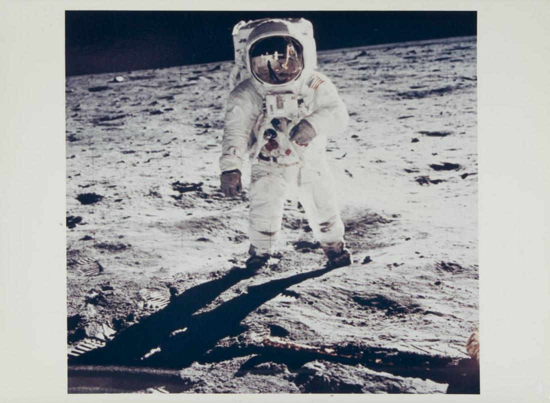 NASA APOLLO 11 BUZZ ALDRIN MOON VISOR REFLECTION: An original NASA color photograph featuring astronaut Edwin Buzz Aldrin standing on the surface of the moon with the lunar module reflected in his visor. The photograph corresponds to image number AS1