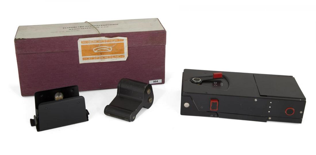 SOVIET KGB SPY C-112 DOCUMENT COPIER: A Soviet KGB spy "C-112" copying device for reproducing classified documents. Includes original instruction manual, box, and film cutter. LITERATURE The Secret History of KGB Spy Cameras by Melton, Al