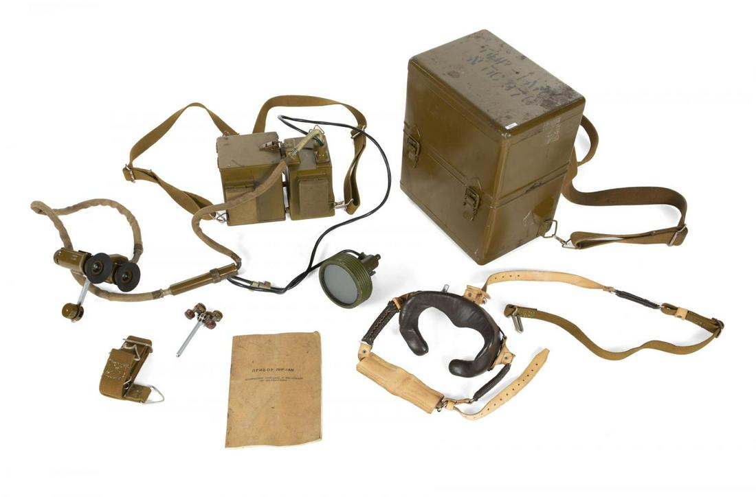 SOVIET KGB SPY NIGHT VISION BINOCULARS: A pair of Soviet KGB Spy night vision binoculars, housed in a metal box with backpack straps. Includes original instruction manual. 12 1/4 by 7 1/2 by 10 inches