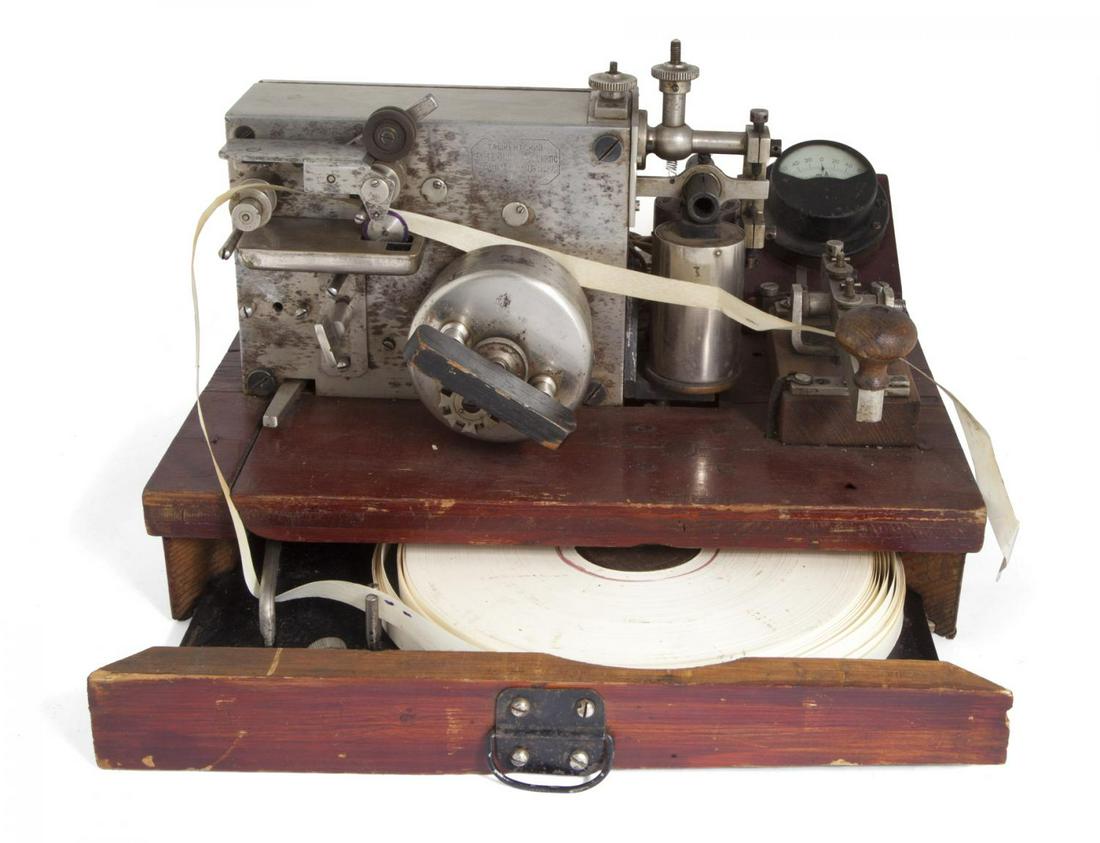 SOVIET ANTIQUE TELEGRAPH MACHINE: An antique Soviet telegraph machine, with manual from 1925. 13 1/4 by 10 1/4 by 8 1/2 inches