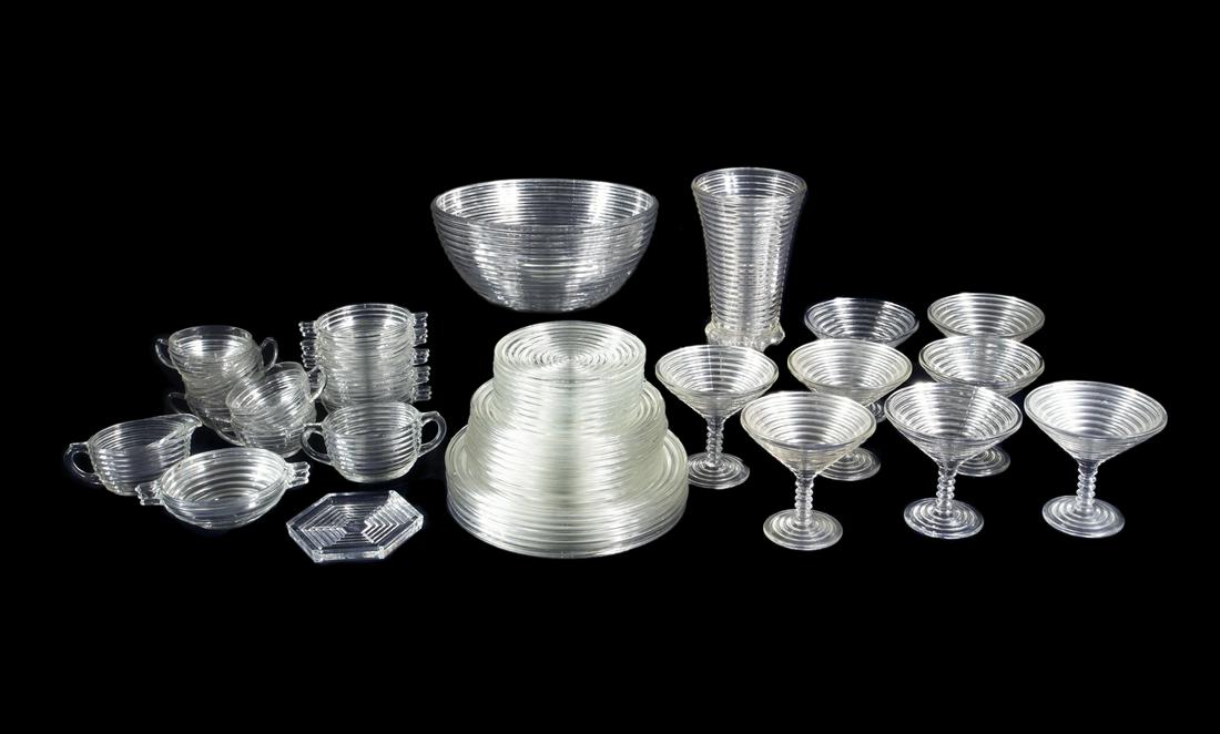 ANCHOR HOCKING MANHATTAN WARE GLASS DISH SET: A dishset of Art Deco style ridged pressed Depression glass including six dinner plates, eight salads, nine bread and butter plates, five soup bowls, one cereal bowl, five coffee cups, eight martini g