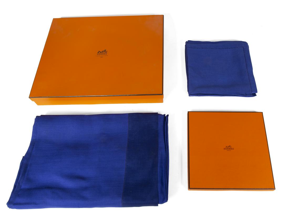 HERMES NAVY TABLE LINENS: A tablecloth and eight matching linen napkins by maker Hermes. In presentation boxes. 95 by 68 inches Box, 4 by 17 1/4 by 17 1/4 inches Fine Art