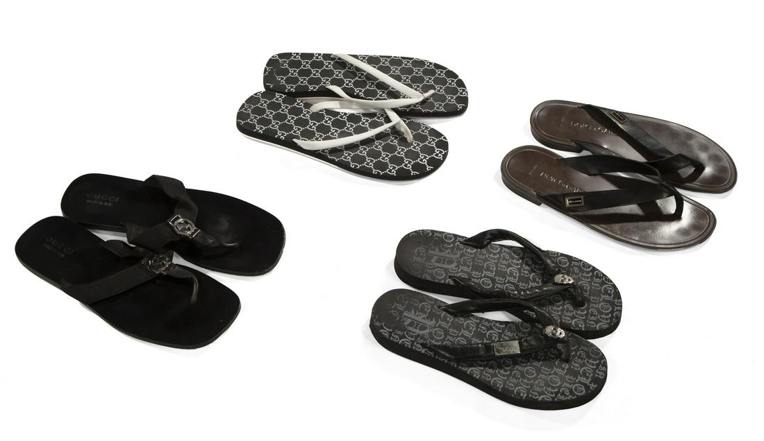 FOUR PAIRS OF DESIGNER SANDALS: A group fo four pairs of luxury brand thong sandals, including: a skull pair by Philipp Plein marked "Limited Edition," size 42; a pair with black leather straps by Dolce & Gabbana; a patterned foam p