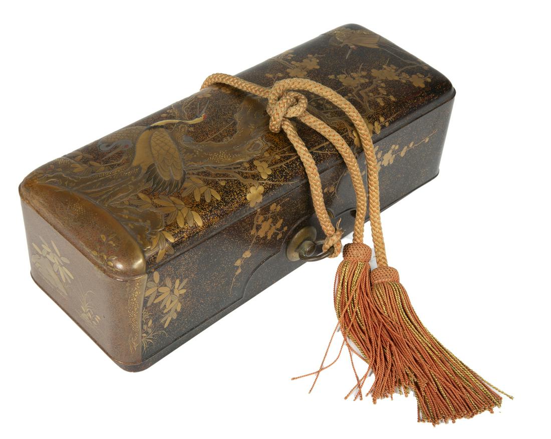 JAPANESE MEIJI PERIOD (1868-1912) LACQUER SCROLL BOX: A black, amber and gold Japanese lacquer box decorated with cranes and a flowering tree. Signed on the inside. 3 1/2 by 11 by 4 inches Fine Art