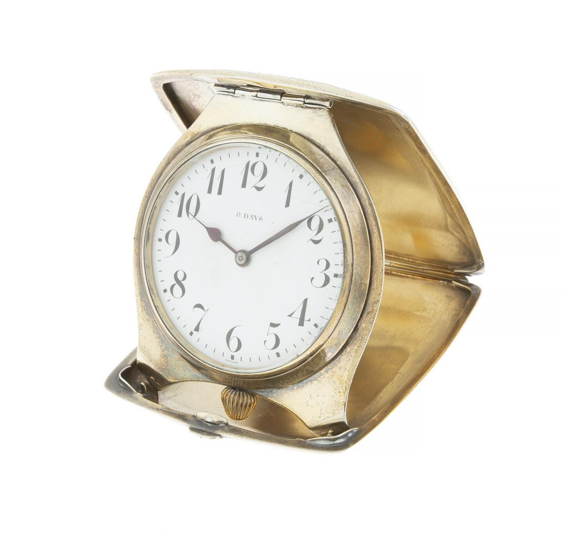 STERLING CLOCK IN MONOGRAMMED CASE: An 8 Days Swiss clock by an American maker in a Florentine pattern decorated case with a monogrammed cartouche. Non weighable. 4 by 3 5/8 inches PROVENANCE From the Collection of Arnold Rifkin Fine Ar