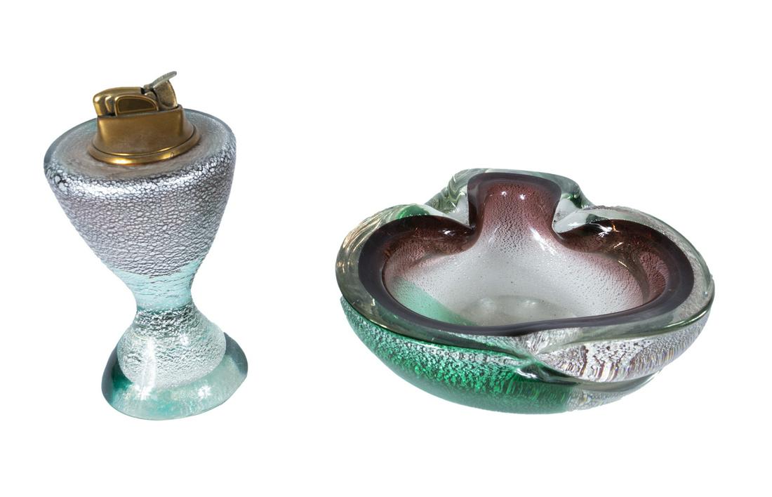 GLASS MURANO STYLE TABLE LIGHTER AND ASH TRAY: A Mid century purple and green glass table lighter and ash tray, both unmarked. Ashtray, 6 1/2 by 6 1/2 inches Fine Art