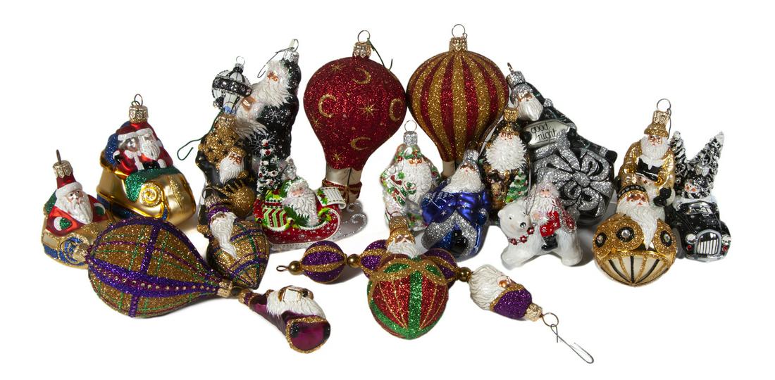 GROUP OF SANTA CLAUS BALLOON ORNAMENTS: A group of handblown and painted glass Santa Claus ornaments with glitter, some with balloons, some black and gold painted, some in sleighs. By Patricia Breen. Approximately 18 pieces. Sizes vary Fine