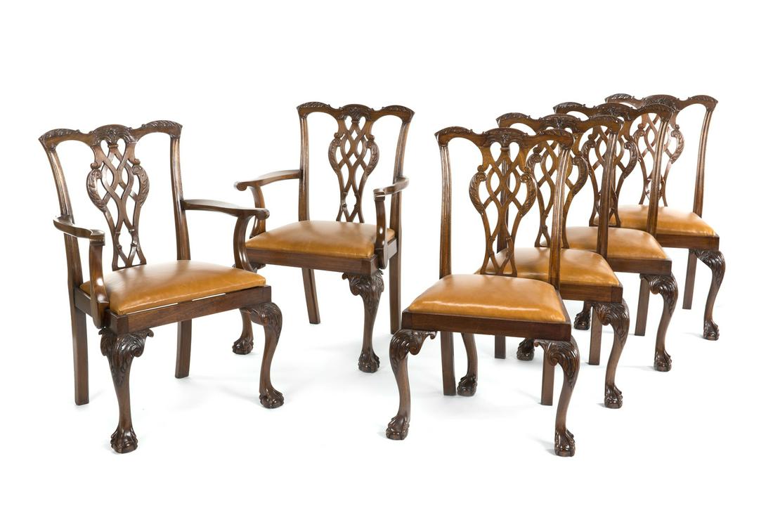 SET OF TWELVE CHIPPENDALE STYLE DINING CHAIRS: 20th century ribband back Chippendale chairs with leather upholstered drop in seats and ball and claw feet. Two armchairs and ten side chairs. Armchairs, 39 1/2 by 28 by 17 inches; Side chairs, 39 1/2
