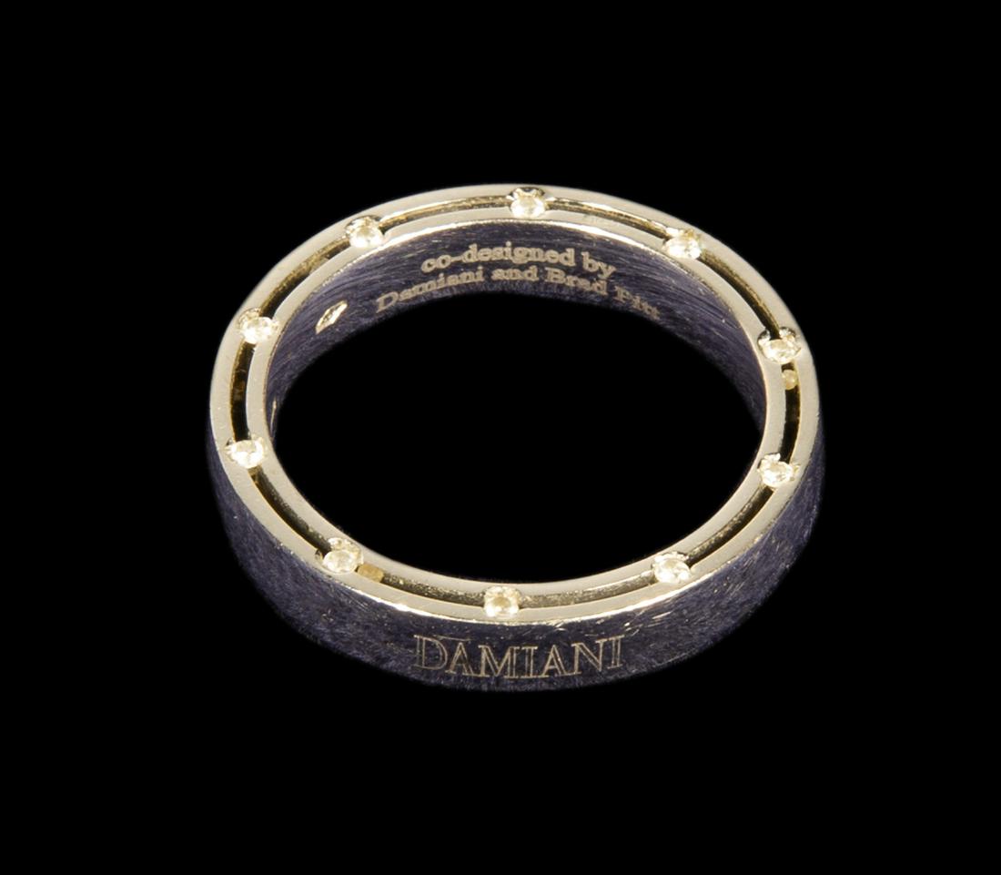 DAMIANI D SIDE BRAD PITT 18K WHITE GOLD 20 DIAMOND RING: A white gold ring inset with 20 diamonds totaling 0.18 carats inset into the borders. Designed by Damiani and Brad Pitt. Size 8 1/4. 7.0 grams. Fine Art