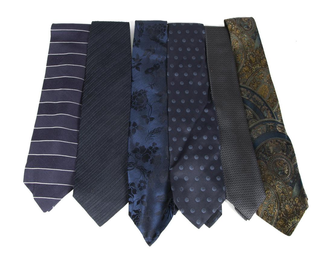 SIX LUXURY BRAND NAVY NECKTIES: A group of six navy silk neckties in assorted patterns, by makers Giorgio Armani(2), Gucci (2), Armani Collezione, and Nogarette Paris. Fine Art