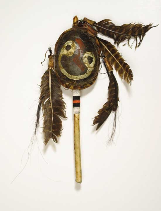 Dances with Wolves Prop Indian Hand Rattle: This hand rattle was made for the 1990 western drama "Dances with wolves" starring Kevin Costner. The hand prop has a fake turtle shell as the rattle with a rawhide back and feathers and bones attache