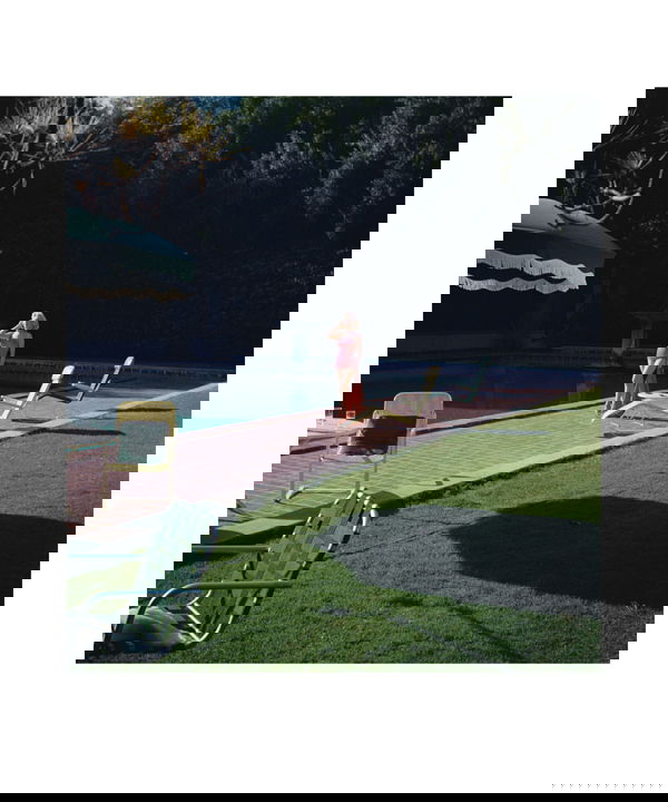 MARILYN MONROE HAROLD LLOYD PHOTOGRAPH PRINT: A limited edition poster print (25/250) featuring a color image of Marilyn (c.1952) during the filming of "How to Marry a Millionaire" (20th Century Fox). Marilyn posed for publicity shots at former s