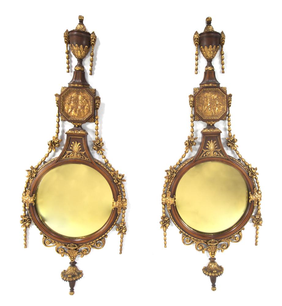 JEAN AND CASEY KASEM PAIR OF NEOCLASSICAL GILTWOOD MIRRORS: A pair of convex Neoclassical giltwood mirrors with putti, bellflower and foliate adornments, urn finials, and acanthus terminals. 50 x 18.5 inches PROVENANCE From The Collection of Jean and Casey Kas