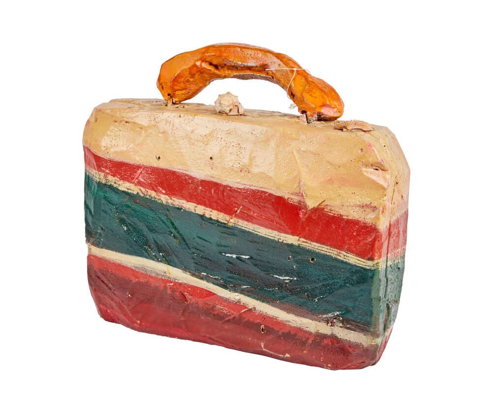 THE FLINTSTONES | JOHN GOODMAN "FRED FLINTSTONE" BRIEFCASE PROP: An original prop briefcase as seen used by John Goodman as "Fred Flintstone" in The Flintstones (Universal Pictures, 1994). This briefcase is composed of a hollow resin material that has been hand-pai