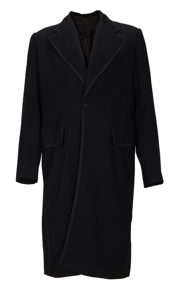 THE SEARCHERS | WARD BOND "REV. CAPT. SAMUEL JOHNSTON CLAYTON" LONG COAT (WITH DVD): A long black coat worn by Ward Bond as Rev. Capt. Samuel Johnston Clayton in John Ford's classic Western The Searchers (Warner Bros., 1956) starring John Wayne. The coat has its original Western Costu