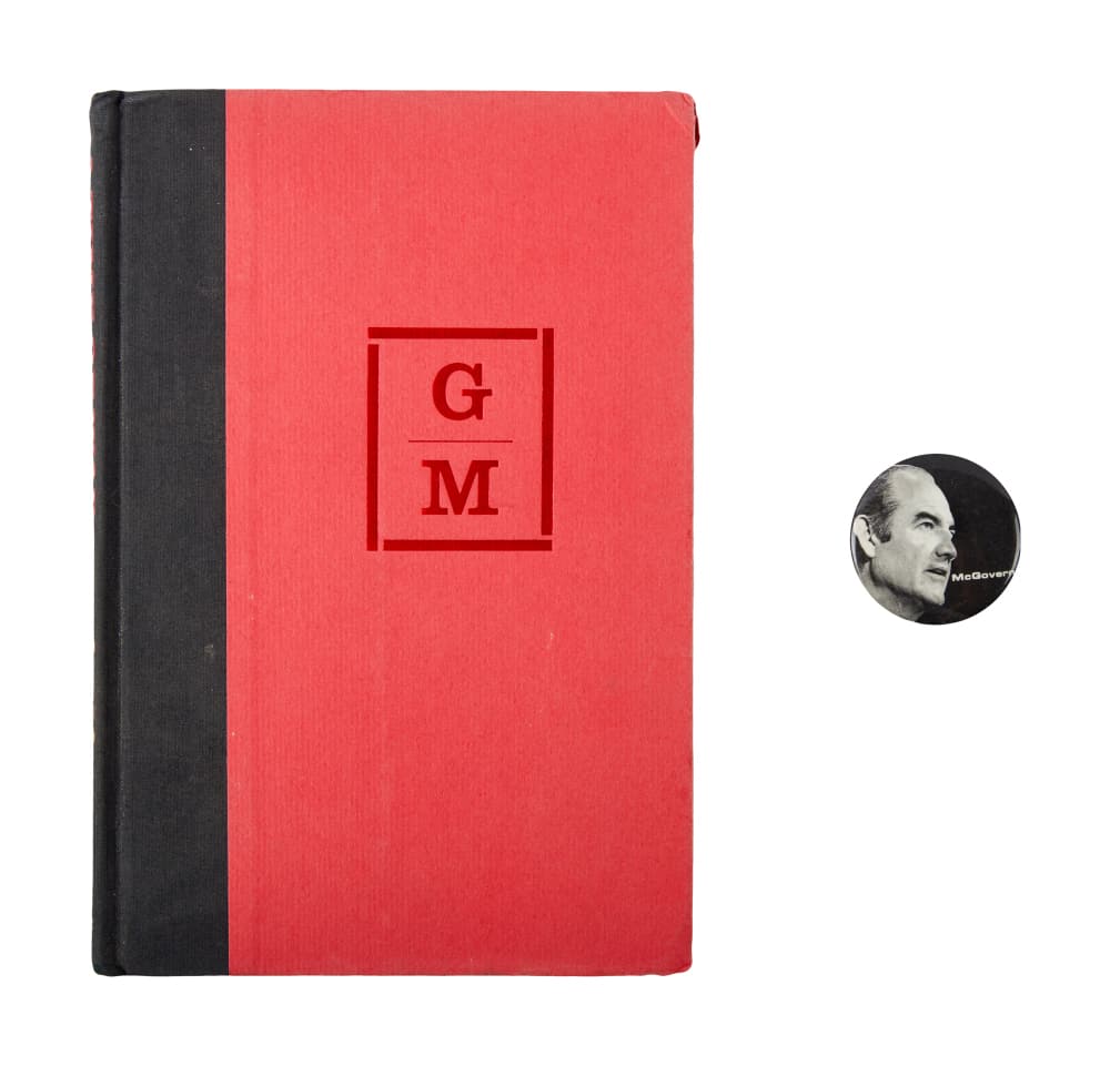 DENNIS HOPPER | GEORGE MCGOVERN-INSCRIBED MEMOIR AND LAPEL PIN: A hardback copy of Senator George McGovern's memoir A Time of War, A Time of Peace (Random House, 1968) that's been inscribed to Dennis Hopper in blue ink by McGovern. Together with a lapel pin featur