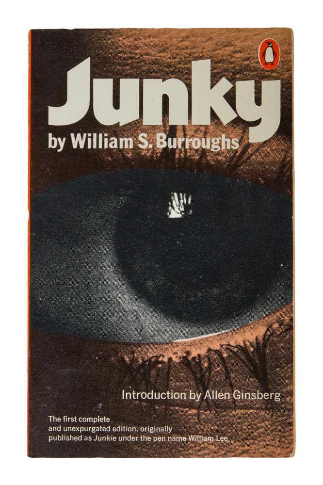 DENNIS HOPPER | PERSONALLY-OWNED "JUNKY" PAPERBACK: A paperback copy of Junky (Penguin Books, 1977) by William S. Burroughs that belonged to Dennis Hopper and was inscribed "Satya Loves You" in ink by Satya de la Manitou, Hopper's close friend and righ