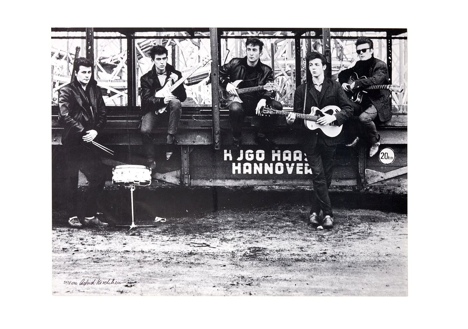 THE BEATLES | ASTRID KIRCHHERR SIGNED LIMITED-EDITION POSTER: A limited-edition black and white poster of The Beatles taken at Heiligengeistfeld Square in Hamburg, Germany, as part of The Beatles’ first photo session in November 1960, and later signed by t