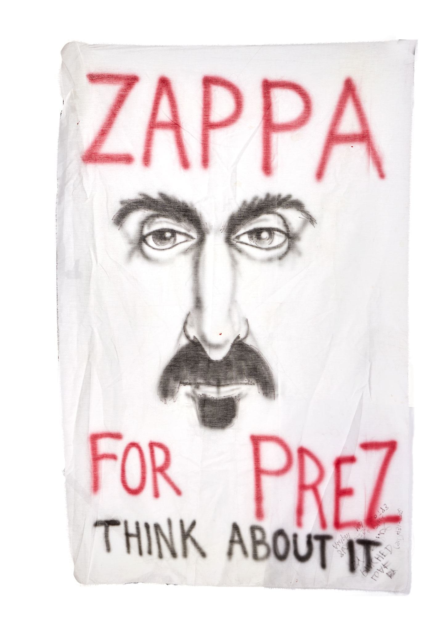 FRANK ZAPPA | "ZAPPA FOR PREZ" FAN-MADE SHEET: A white sheet airbrushed with red and black ink and detailed with black marker featuring Frank Zappa's face and the words "ZAPPA FOR PREZ - THINK ABOUT IT" on the front. Written in black
