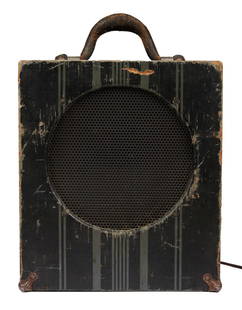 ZZ TOP | DUSTY HILL EARLY GIBSON AMPLIFIER: Circa 1935 Gibson E-100 tube amplifier with "Jensen Electrodynamic" speaker in striped wood case with leather handle. Modern grounded power cord has been added. PROVENANCE From The Estate