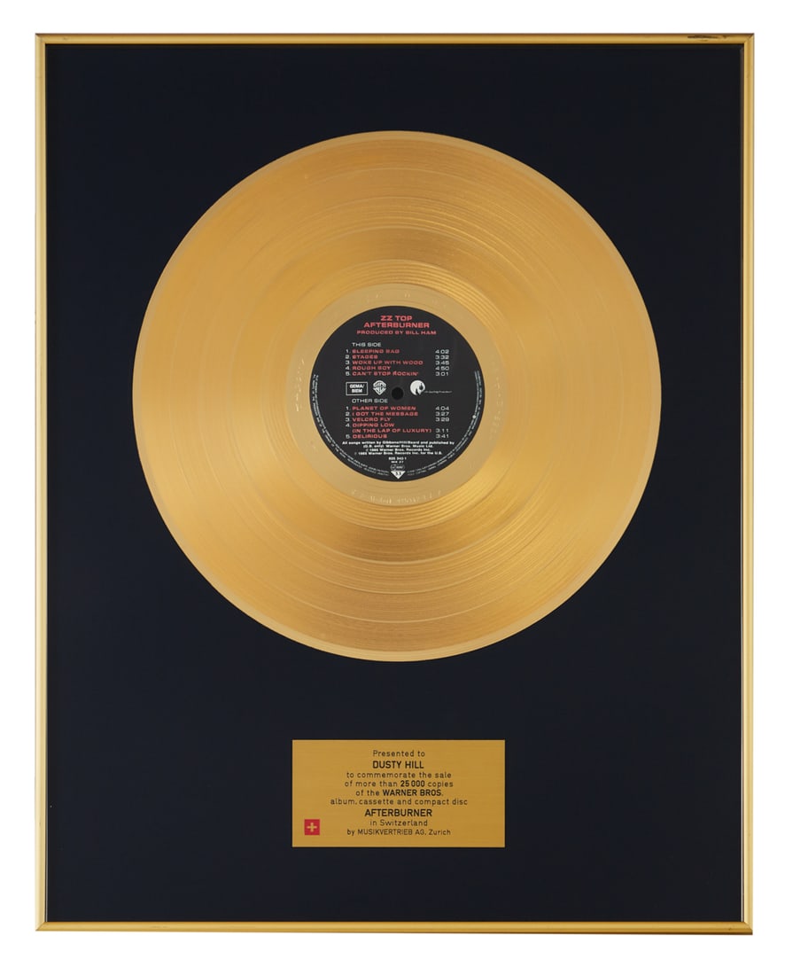 ZZ TOP | DUSTY HILL AFTERBURNER SWISS RECORD AWARD: A Swiss gold record award presented by Musikvertrieb AG, Zurich to Dusty Hill to commemorate the sale of more than 25,000 copies of Afterburner. Dimensions: 20 1/4 by 16 1/4 inches PROVENANCE From The