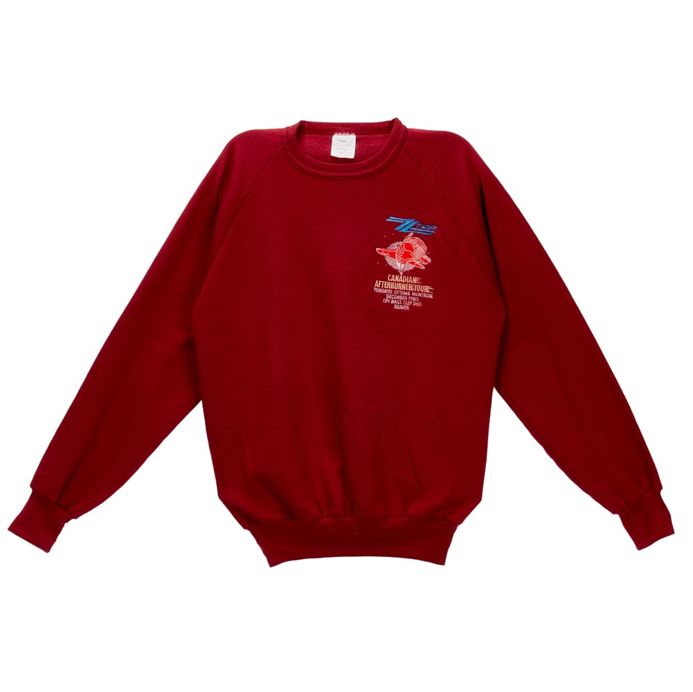 ZZ TOP | DUSTY HILL AFTERBURNER TOUR CLOTHING: A blue Afterburner sweatshirt with gold thread "ZZ Top" embroidered to front and "Their Mission: / Canada / Afterburner / 1985" in white puffy letters on back, size XL. Together wi