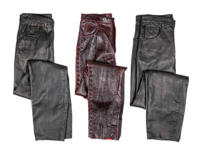 ZZ TOP | DUSTY HILL LEATHER TROUSERS: Two pairs of black leather button fly trousers by Michael Hoban, North Beach leathers. Together with a pair of red leather trousers with black laced outer seams and black stretch inner seam panels, no